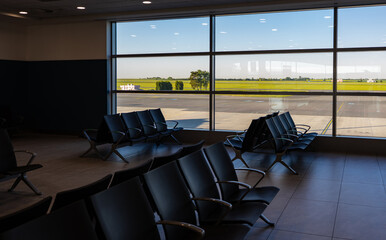 Empty waiting area with seats in a modern international airport terminal.