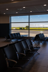 Empty waiting area with seats in a modern international airport terminal.
