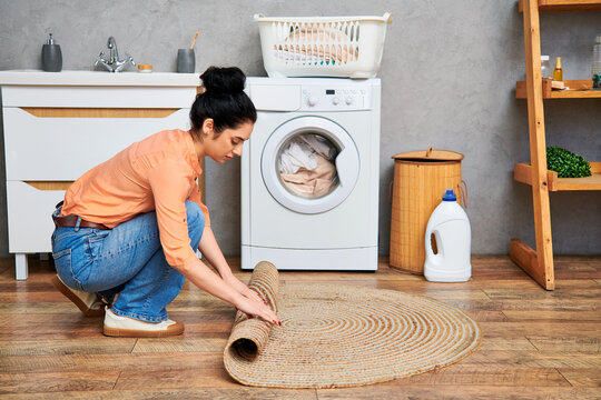 Young woman tidying up her stylish apartment during a spring cleaning session