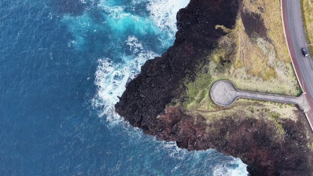 Aerial view over volcanic coast, Atlantic ocean waves, Azores, Sao Miguel island, travel destination.