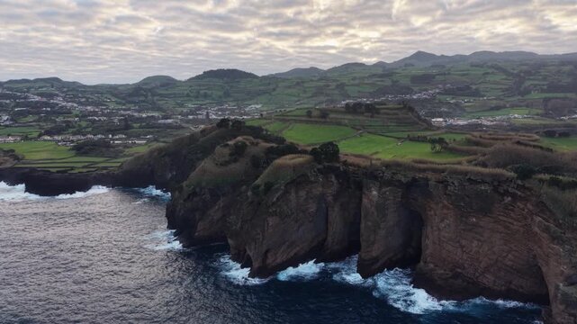 Aerial view over volcanic coast, Atlantic ocean waves, Azores, Sao Miguel island, travel destination.