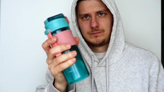 Sports nutrition and protein in a blue bottle.
A healthy post-workout drink for athletes.
Nutritional supplements for sports.
Plastic sports bottle