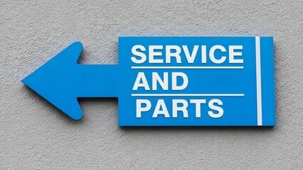 Blue Service and Parts Directional Sign with Arrow Pointing Left on Textured Grey Wall