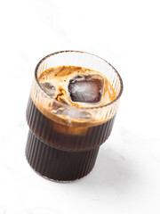 iced coffee with ice in a clear glass in the white background