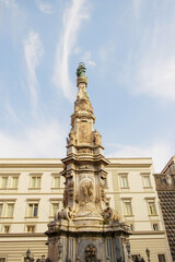 View of the Obelisk of the Immaculate Conception, a historic monument located in Naples, Campania, Italy.