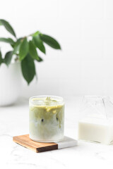 Matcha tea. Iced green tea matcha latte in glass. Green tea dalgona, whipped green tea with milk. Healthy vegan drink, close up.