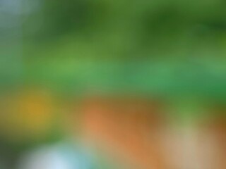 Abstract blurred green and orange background with soft bokeh effect for creative design use