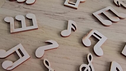 Crafting music notes from wood at a workshop in the afternoon sun