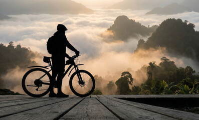 Mountain Biker Silhouette at Scenic Sunrise Over Misty Mountains ai generated