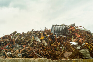 Pile of old rusty old rusty metal plates. Metal waste. Scrap metal on a construction site. Scrap yard with scrap metal. Selective focus