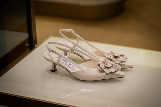 Milan, Italy - 2026, 13 Jan: Elegant Jimmy Choo FW25 beige slingback heels with floral embellishments displayed in a chic boutique, highlighting refined luxury and modern style