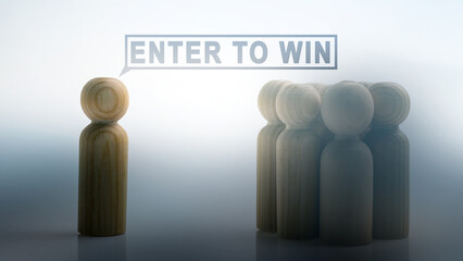 Wooden figure inviting others to "Enter to Win." Concept of online contest, giveaway, raffle, or lottery