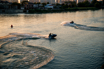 two men riding jet skis on water