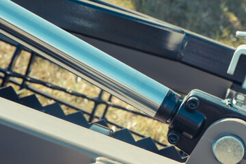 Black pistons or actuators in gray pneumatic or hydraulic machine. Technology