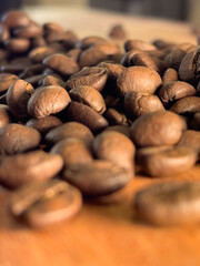 Close up view of roasted coffee beans creating a warm natural texture background. 