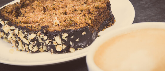 Fresh pastry made of zucchini and cup of white coffee. Delicious dessert. Vintage photo