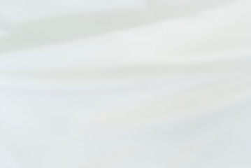 Obraz premium The bright white satin fabric texture is wavy and beautiful and luxurious. For background and backdrop.