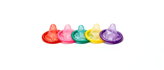 Safe Sex Education Concept with Colorful Condoms Isolated on White Background.