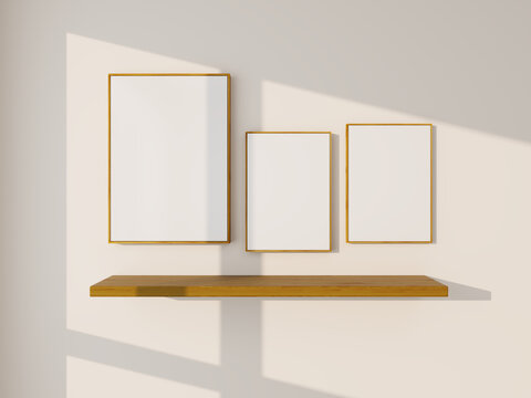 Three wooden empty frames mockup on white wall with wood shelf. 3 posters mockup, with light reflection
