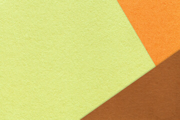 Fototapeta premium Abstract light green, orange and brown paper background with copy space. Template for presentation, banner, card design