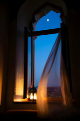 Crescent Moon Through Arched Window with Glowing Lantern Inside, Ramadan Kareem Night, Jumma Mubarak Serenity, Peaceful Evening Reflection