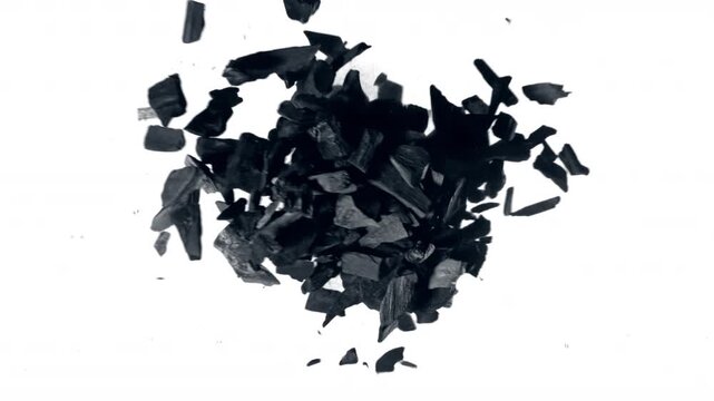 Super Slow Motion Flying and Colliding Charcoal Isolated On White Background at 1000 fps.