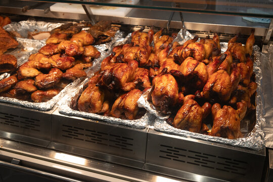 SINGAPORE - DECEMBER 27, 2025: A wide variety of fresh tropical fruits, Halal-certified Australian beef, and prepared sushi platters displayed inside a modern FairPrice Xtra supermarket.