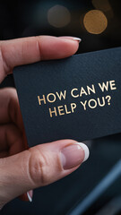 Fototapeta premium Hand holding black business card with gold 