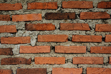 Obraz premium Old Weathered Red Brick Wall Background with Grey Cement Mortar