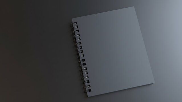 Minimalist dark grey spiral notebook with silver binding rests on a textured dark surface, clean and modern design concept, top-down view.