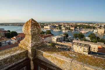 High viewpoint panoramic view of Zadar old town with red tiled roofs and Adriatic Sea seen from the bell tower. Travel destination cityscape with historic architecture and coastal horizon.
