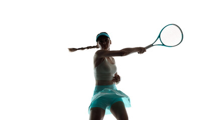 Female tennis player powerful forehand swing in studio. Concept of sportswear advertising, tennis training visuals, athlete performance marketing with focus and strength.
