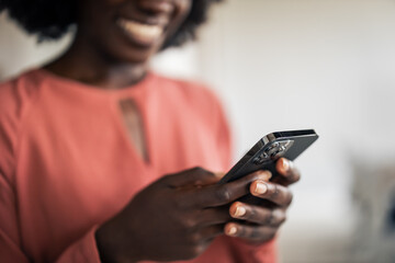 African woman connecting online using smartphone app
