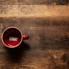 Red coffee cup with the word Start inside on a rustic wooden table