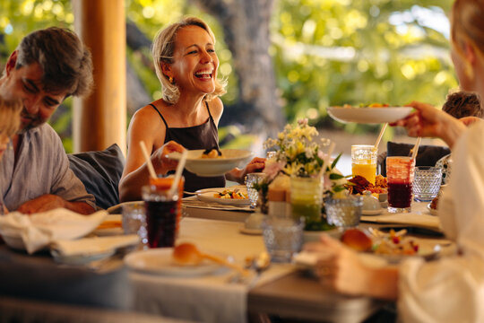 Joyful laughter during brunch at a luxurious island villa with friends