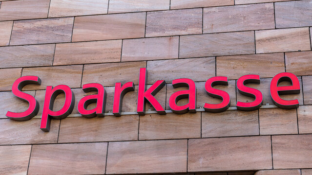 Roter Sparkasse-Schriftzug an einer Fassade aus Sandsteinplatten in der F&uuml;rther Stra&szlig;e in N&uuml;rnberg, als Detailaufnahme fotografiert.