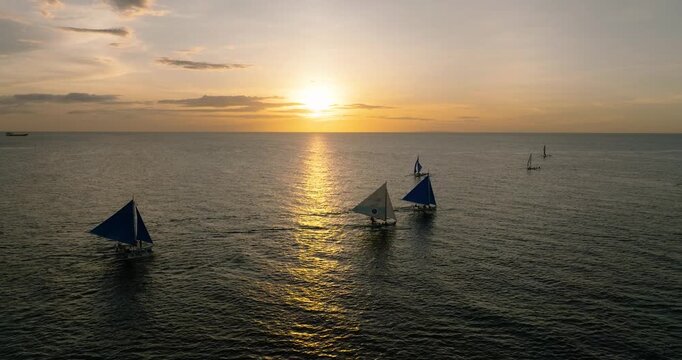 Sunset background of sailing boats over the sea. Boracay, Philippines.
