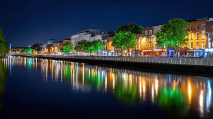 Fototapeta premium Stunning nighttime view of Dublin city center with glowing green lights reflecting on the water surface in vibrant cityscape setting