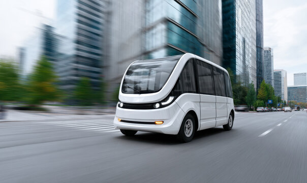 White Autonomous Shuttle bus driving through the city with modern buildings.