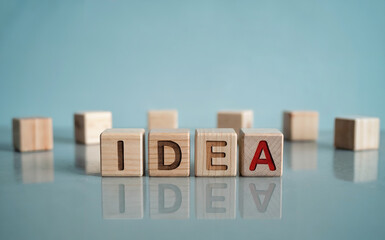 Wooden Blocks Spelling Word IDEA with Red Letter A on Blue Background for Creativity Concept