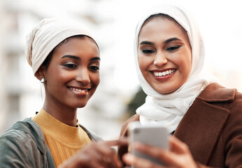 Women, muslim and travel with smartphone in city for directions, sightseeing or weekend trip. Friends, online and hijab people with smile for adventure, navigation or tourist in urban town in Dubai