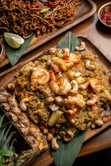 Thai chicken fried rice with pineapple and cashew on modrn bangkok restaurant table in thailand