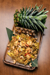 Thai chicken fried rice with pineapple and cashew on modrn bangkok restaurant table in thailand