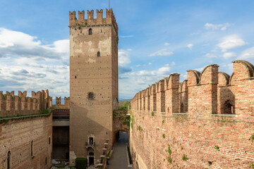 Medieval tower in Verona, Italy, showcasing its brick walls and battlements.