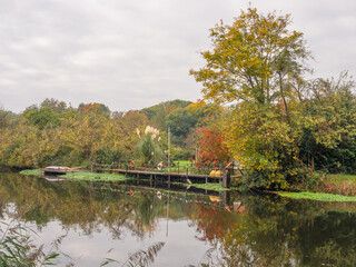 Fototapeta premium Lovely autumn reflections in the river Weaver at Northwich, Cheshire, UK