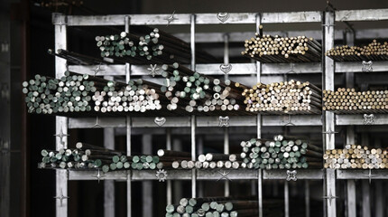 Shelving Unit Filled with Rows of Metal Rods and Bars photo metallic