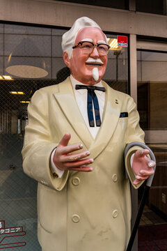 Kamakura, Japan - April 17, 2025 Colonel Sanders' statue outside the restaurant entrance in Japan, showing the iconic brand mascot and popular fast food culture