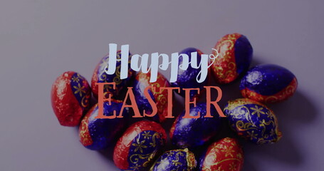 Image of happy easter text over colourful easter eggs on purple background