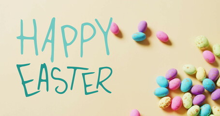 Image of happy easter text over colourful easter eggs on yellow background