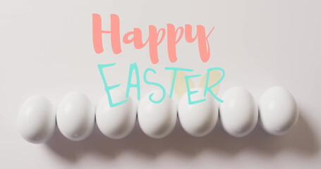 Image of happy easter text over white easter eggs on white background